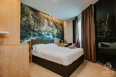 a bedroom with a bed with a large painting on the wall at Ipoh Town Area Avs Hotel by Verve in Ipoh