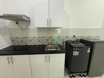 a small kitchen with a sink and a refrigerator at 3pax Suite Ipoh Town The Anderson Residence #147 in Ipoh