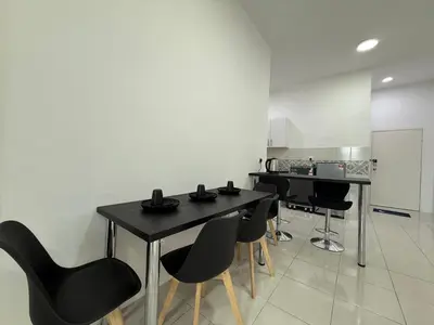 a kitchen with a black table and black chairs at 3pax Suite Ipoh Town The Anderson Residence #147 in Ipoh