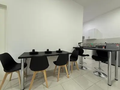 a kitchen with black tables and black chairs at 3pax Suite Ipoh Town The Anderson Residence #147 in Ipoh