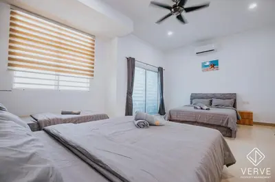 a bedroom with two beds and a ceiling fan at Ipoh Summer Suite by Veve EECH05 in Gua Sai