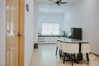 a kitchen with a table and chairs and a refrigerator at Ipoh Summer Suite by Veve EECH05 in Gua Sai