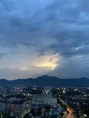 a view of a city at night with the mountains at Piccadilly Greentown by Jun Residence in Ipoh