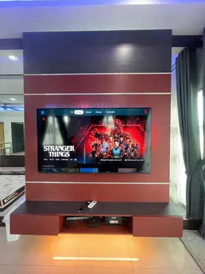 a large flat screen tv in a living room at Afiq's Homestay, Manjung in Seri Manjung