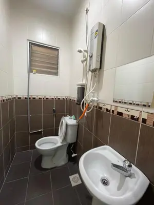 a bathroom with a toilet and a sink at Afiq's Homestay, Manjung in Seri Manjung