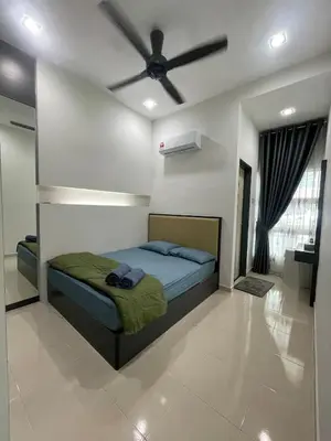 a bedroom with a bed with a ceiling fan at Afiq's Homestay, Manjung in Seri Manjung