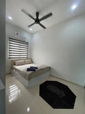 a bedroom with a bed with a ceiling fan at Afiq's Homestay, Manjung in Seri Manjung