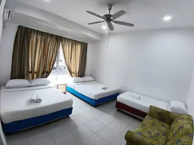 a hotel room with two beds and a ceiling fan at Raub Colonial 208 Homestay in Raub