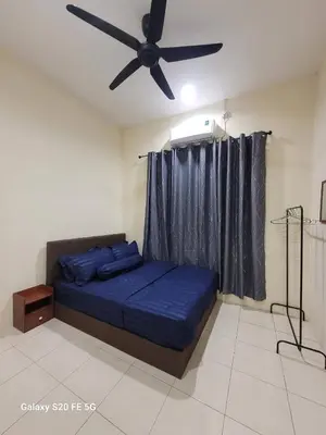 a bedroom with a bed with a ceiling fan at Rizqullah Homestay Ipoh in Ipoh