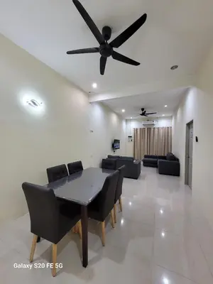 a living room with a ceiling fan and a table and chairs at Rizqullah Homestay Ipoh in Ipoh
