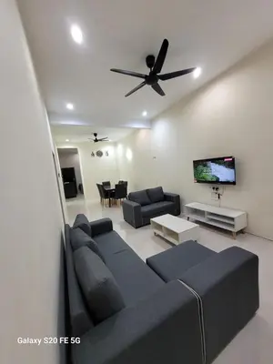 a living room with a couch and a ceiling fan at Rizqullah Homestay Ipoh in Ipoh
