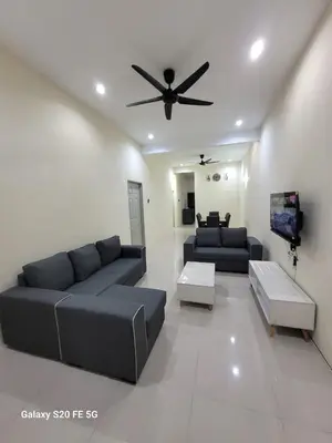 a living room with a couch and a ceiling fan at Rizqullah Homestay Ipoh in Ipoh