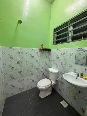 a bathroom with a toilet and a sink at Wawa Homestay Ipoh in Ipoh