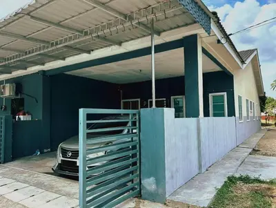 a house with a fence and a car parked under it at Wawa Homestay Ipoh in Ipoh