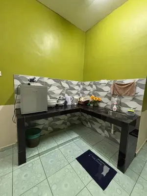 a room with a table with a tv on it at Wawa Homestay Ipoh in Ipoh
