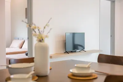 a living room with a table with a vase of flowers at Serene Japandi & Zen Family Retreat 2-7 pax with Comfortable Living Space in Tanah Rata