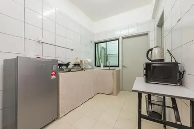 a kitchen with a refrigerator and a table with a tv at Serene Japandi & Zen Family Retreat 2-7 pax with Comfortable Living Space in Tanah Rata