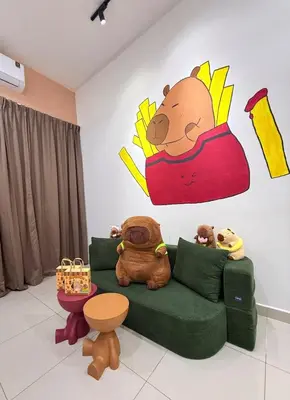 a living room with a couch with stuffed animals on it at Pantai Remis Capybara House in Pantai Remis