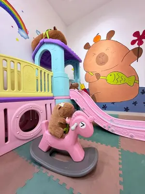 a childs play room with a pink elephant and a playset at Pantai Remis Capybara House in Pantai Remis