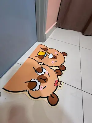 a floor mat with three cartoon dogs on it at Pantai Remis Capybara House in Pantai Remis