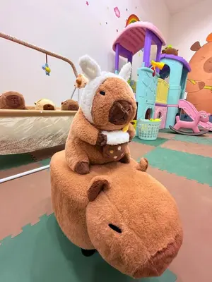 a teddy bear sitting on top of a chair at Pantai Remis Capybara House in Pantai Remis