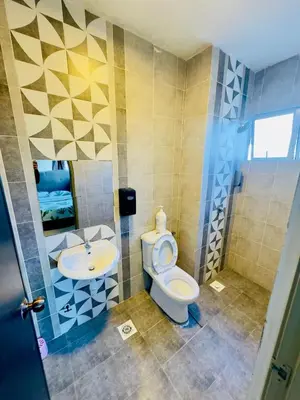 a bathroom with a toilet and a sink at Icolor Ch 7 in Tanah Rata