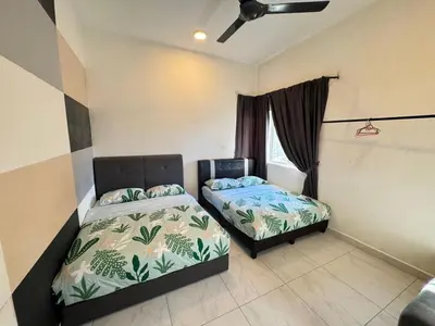 a bedroom with two beds and a ceiling fan at Icolor Ch 7 in Tanah Rata