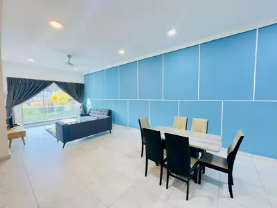a dining room with a table and chairs and a couch at Icolor Ch 7 in Tanah Rata