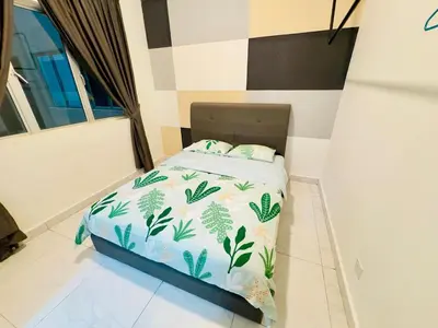 a small bed in a room with a bedspread with plants at Icolor Ch 7 in Tanah Rata