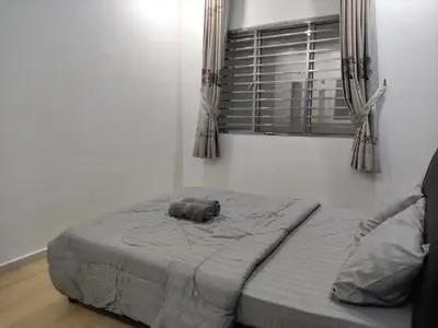 a bed in a room with a window at Cozyhaus Stay Sanctuary-Netflix-Pool- 1 Parking in Taiping