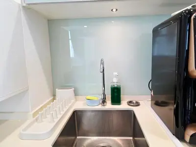 a kitchen counter with a sink and aaucet at StayLuxe SGS 2BR Suite in George Town