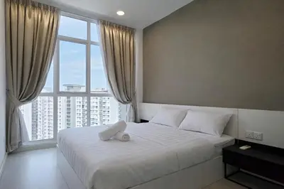 a bedroom with a white bed with a large window at StayLuxe SGS 2BR Suite in George Town