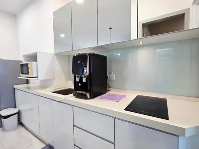 a kitchen with a black appliance on a counter at StayLuxe SGS 2BR Suite in George Town