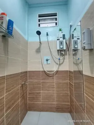 a bathroom with a shower stall with a shower at Adno Homestay Batu Kawan 2QB1SB in Simpang Ampat