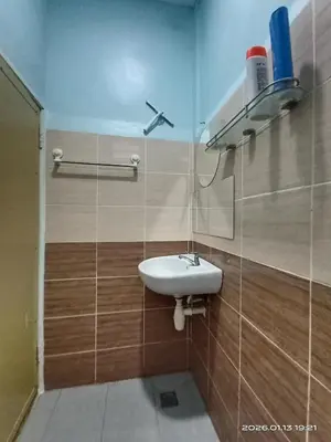 a bathroom with a sink on a tiled wall at Adno Homestay Batu Kawan 2QB1SB in Simpang Ampat