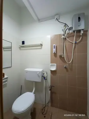 a bathroom with a toilet and a shower at Adno Homestay Batu Kawan 5SB in Simpang Ampat