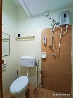 a bathroom with a toilet and a shower at Adno Homestay Batu Kawan 5SB in Simpang Ampat
