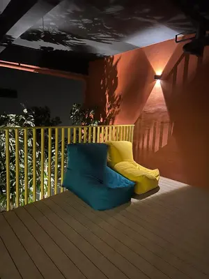 a balcony with colorful pillows on a deck at Piccadilly Green Town Luxury Stay, Ipoh in Ipoh