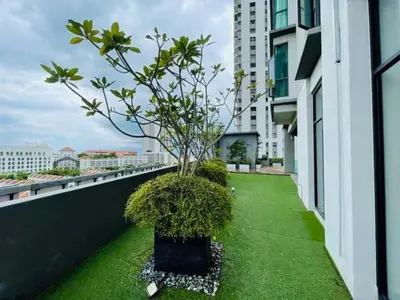 a small tree on the balcony of a building at Peaceful Seaview Getaway Jazz Suite High Floor in Tanjong Tokong