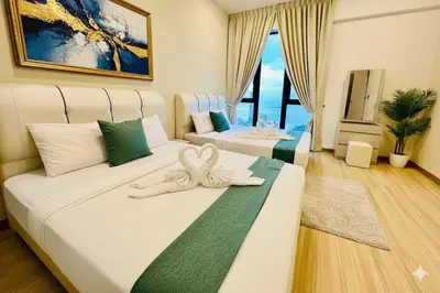 two beds in a hotel room with a room at Peaceful Seaview Getaway Jazz Suite High Floor in Tanjong Tokong