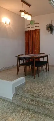 a dining room with a table and a bench at D Seberang Homestay in Perai
