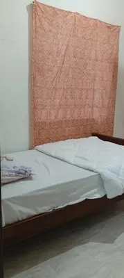a bedroom with a bed with a orange headboard at D Seberang Homestay in Perai