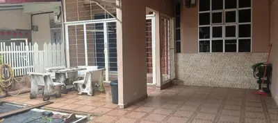 an open door to a patio with a table and chairs at D Seberang Homestay in Perai