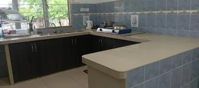 a kitchen with a sink and a counter top at D Seberang Homestay in Perai