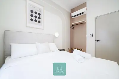 a bedroom with a white bed with a sign on it at JOMSTAY - Piccadilly Greentown Ipoh in Ipoh