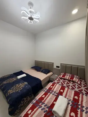 a bedroom with two beds and a ceiling fan at Ayaan Platinum2 Homestay at Tanah Rata with Private Parking and Air Hockey Games in Tanah Rata