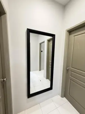 a mirror on a wall next to a door at Ayaan Platinum2 Homestay at Tanah Rata with Private Parking and Air Hockey Games in Tanah Rata