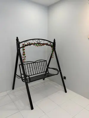 a black metal shopping cart with flowers on it at Ayaan Platinum2 Homestay at Tanah Rata with Private Parking and Air Hockey Games in Tanah Rata