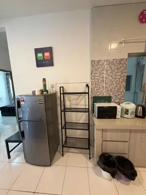 a kitchen with a stainless steel refrigerator and a counter at AYAAN Freesia Snooker House at Quintet Private Parking in Tanah Rata