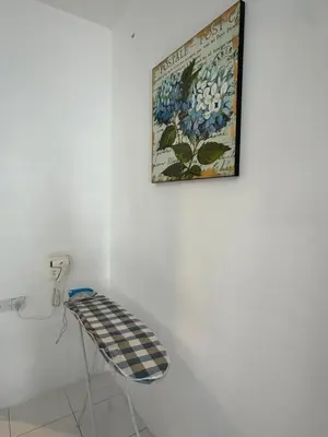 a picture hanging on a wall next to a stool at AYAAN Freesia Snooker House at Quintet Private Parking in Tanah Rata